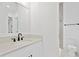 Bathroom with quartz vanity, modern black hardware, framed mirror, and glass-enclosed shower at 429 Erie Ave, Tampa, FL 33606
