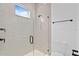 Modern bathroom with tiled glass shower enclosure, sleek fixtures, and window at 429 Erie Ave, Tampa, FL 33606