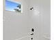 Clean bathroom with white subway tile, tub, shower, and black fixtures at 429 Erie Ave, Tampa, FL 33606