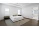 Bedroom with light gray rug, white bedding and bedside tables at 429 Erie Ave, Tampa, FL 33606