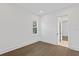 An empty bedroom featuring a large window, hardwood floors, and a doorway at 429 Erie Ave, Tampa, FL 33606