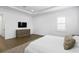 Bedroom featuring a tv, light gray rug, white bedding and tray ceiling at 429 Erie Ave, Tampa, FL 33606