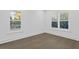 A room with hardwood floors and white walls with two shuttered windows at 429 Erie Ave, Tampa, FL 33606
