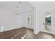 Elegant dining room with a modern chandelier, plantation shutters, and neutral decor at 429 Erie Ave, Tampa, FL 33606