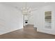 Dining room boasting designer feature wall, hardwood floors, and a modern gold chandelier at 429 Erie Ave, Tampa, FL 33606