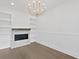 Bright dining room features a fireplace, custom shelving, and modern gold chandelier at 429 Erie Ave, Tampa, FL 33606