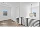 Second floor hallway with window views, dark wood floors and black railing at 429 Erie Ave, Tampa, FL 33606