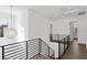Hallway with dark wood floors, black railings, and modern globe pendant light at 429 Erie Ave, Tampa, FL 33606