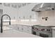 Close-up of kitchen with white cabinets, marble backsplash, and stainless steel range at 429 Erie Ave, Tampa, FL 33606