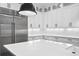 Modern kitchen features stainless steel appliances, custom white cabinets, and a stylish backsplash at 429 Erie Ave, Tampa, FL 33606