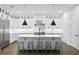 Stylish, white kitchen with large island, marble backsplash, stainless steel appliances at 429 Erie Ave, Tampa, FL 33606