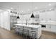 Bright white kitchen featuring a large island with barstool seating and modern pendant lighting at 429 Erie Ave, Tampa, FL 33606
