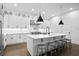 Bright white kitchen showcasing a large island with seating and stainless steel appliances at 429 Erie Ave, Tampa, FL 33606