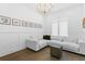 Comfortable living room with a plush sectional sofa, wood floors, and a modern chandelier at 429 Erie Ave, Tampa, FL 33606
