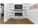Inviting living room featuring a fireplace with built-in shelving and wood floors at 429 Erie Ave, Tampa, FL 33606