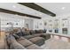 Open concept living area with dark wood beams and access to kitchen and patio at 429 Erie Ave, Tampa, FL 33606