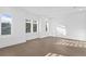 Bright living room featuring hardwood floors, large windows, and white trim and paint at 429 Erie Ave, Tampa, FL 33606