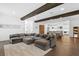 Expansive living room with gray sectional, dark wood beams, and open floor plan at 429 Erie Ave, Tampa, FL 33606