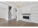 Bright living room featuring a decorative fireplace, hardwood floors, and a staircase at 429 Erie Ave, Tampa, FL 33606