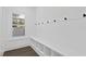 Mudroom with coat hooks, bench seating and built-in cubbies with a window providing natural light at 429 Erie Ave, Tampa, FL 33606