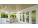 A covered patio features an outdoor kitchen with a built-in grill and access to the home's interior at 429 Erie Ave, Tampa, FL 33606