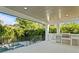 Outdoor kitchen with stainless steel appliances, a small pool, and tropical landscaping at 429 Erie Ave, Tampa, FL 33606