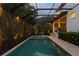 The screened pool features a spa, lush greenery, and direct access to the home's backyard living spaces at 429 Erie Ave, Tampa, FL 33606