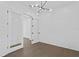 Bright room with modern chandelier, white walls and dark wood floors at 429 Erie Ave, Tampa, FL 33606