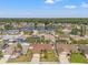 Aerial view of home in residential area with lake view and palm trees at 4410 Foxboro Dr, New Port Richey, FL 34653