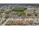 Aerial view of single Gathering homes in a residential area with mature trees and a lake at 4410 Foxboro Dr, New Port Richey, FL 34653