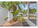 Backyard featuring tropical plants, pavers and a white fence at 4410 Foxboro Dr, New Port Richey, FL 34653