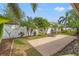 Concrete patio and stainless grill in a landscaped backyard with a white fence at 4410 Foxboro Dr, New Port Richey, FL 34653