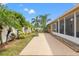 Landscaped backyard with grill, white fence, and tropical plants at 4410 Foxboro Dr, New Port Richey, FL 34653