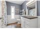 The bathroom has a white sink vanity, a toilet, and decorative shelves at 4410 Foxboro Dr, New Port Richey, FL 34653