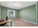 The bedroom has wood floors and a large window at 4410 Foxboro Dr, New Port Richey, FL 34653