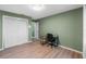 This bedroom features wood floors and a small desk at 4410 Foxboro Dr, New Port Richey, FL 34653