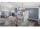 Open layout dining area connected to living room, featuring modern chandelier and beautiful flooring at 4410 Foxboro Dr, New Port Richey, FL 34653