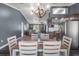Dining area with modern chandelier and wood flooring leading into other living spaces at 4410 Foxboro Dr, New Port Richey, FL 34653