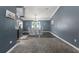 Open-concept dining room with modern table set, lighting fixture and stainless steel refrigerator at 4410 Foxboro Dr, New Port Richey, FL 34653