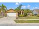 Charming single-story home featuring a well-manicured lawn and attached two-car garage at 4410 Foxboro Dr, New Port Richey, FL 34653