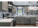 Updated kitchen featuring stainless appliances, countertops, tiled backsplash and wood floors at 4410 Foxboro Dr, New Port Richey, FL 34653