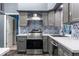 A well lit kitchen featuring stainless appliances, tiled backsplash and modern sink and faucet at 4410 Foxboro Dr, New Port Richey, FL 34653