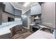 A bright kitchen featuring updated cabinetry, countertops, tiled backsplash and wood flooring at 4410 Foxboro Dr, New Port Richey, FL 34653