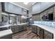 Modern kitchen with gray cabinets, stainless steel appliances, and bright countertops with stylish backsplash at 4410 Foxboro Dr, New Port Richey, FL 34653