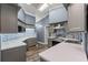 A well lit kitchen featuring countertops, tiled backsplash, wooden floors and stainless appliances at 4410 Foxboro Dr, New Port Richey, FL 34653