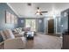 Comfortable living room featuring a plush sectional sofa, stylish decor, and natural light at 4410 Foxboro Dr, New Port Richey, FL 34653