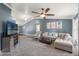 Spacious living room with vaulted ceilings, a ceiling fan, and comfortable seating arrangement at 4410 Foxboro Dr, New Port Richey, FL 34653