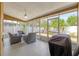 Covered patio with outdoor furniture, a ceiling fan, and a grill at 4410 Foxboro Dr, New Port Richey, FL 34653