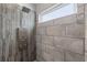 Shower featuring wood-look tile, a showerhead, and multi-jet settings at 4410 Foxboro Dr, New Port Richey, FL 34653
