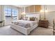 Serene bedroom with a large bed, pendant lighting, and a view of the neighborhood, offering comfort and style at 4419 Rachel Falls Dr, Tampa, FL 33610